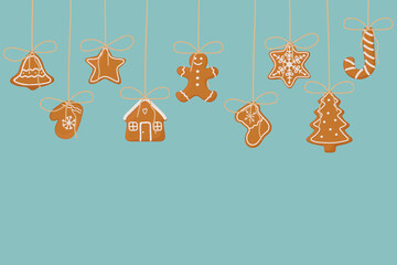 Hanging gingerbread cookies on blue background. Christmas template for banner, greeting card