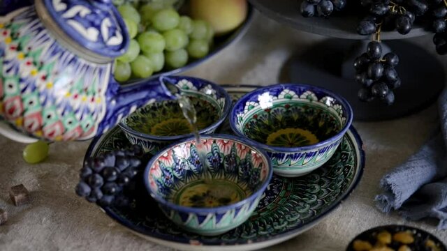 Woman pouring tea in the cup in Uzbekistan