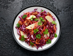 Red Cabbage salad with carrots, apples and pecan nuts. Healthy vegan food