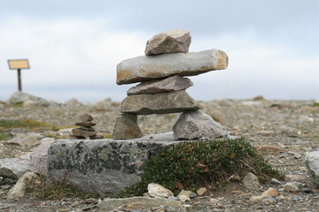 Stone figure inuksuit piled on top of mountain