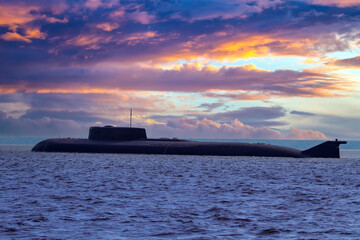 Submarine on the background of beautiful sky. Multicolored clouds over the sea and the submarine....