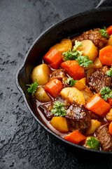 Beef Stew with carrot and baby potato in iron cast pan