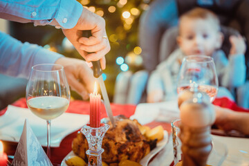Man of the house cutting traditional Christmas food