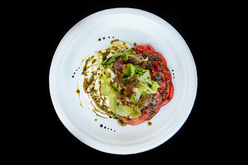 Vegetable salad with tomato cheese, on a white plate, isolate.