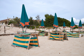 San Pietro in Bevagna, Italy - September 02, 2020 : View of sunbeds and umbrellas at San Pietro beach