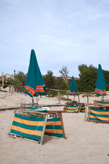 San Pietro in Bevagna, Italy - September 02, 2020 : View of sunbeds and umbrellas at San Pietro beach