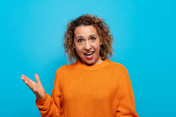 middle age woman looking happy, arrogant, proud and self satisfied, feeling like a number one