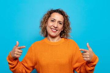 middle age woman looking proud, arrogant, happy, surprised and satisfied, pointing to self, feeling...