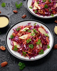 Red Cabbage salad with carrots, apples and pecan nuts. Healthy vegan food