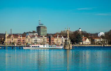 Fototapeta na wymiar Konstanz, Germany , February 25, 2019. View of Lake Boden and the statue of the Empire from the bay in good sunny weather for the day