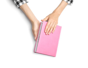 Woman with notebook on white background, top view. Closeup of hands