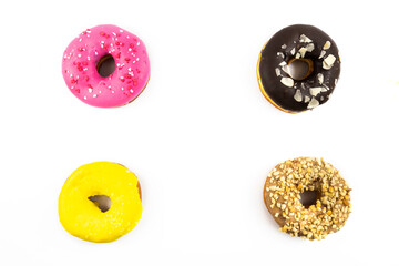 Four assorted donuts chocolate strawberry and others top view on white isolated background