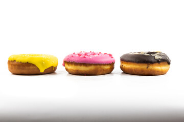 Assorted multicolored sweet donuts side view on white isolated background