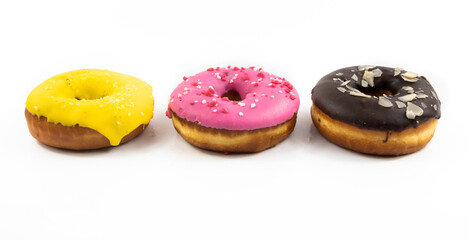 Assorted multicolored sweet donuts side view on white isolated background banner