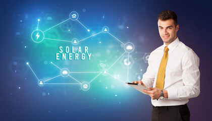 Businessman in front of cloud service icons with SOLAR ENERGY inscription, modern technology concept