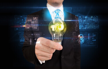 Fototapeta na wymiar Businessman holding lightbulb with STOP FRAUD inscription, online security idea concept