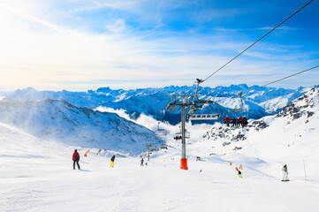 Ski resort in winter Alps. Skiers ride down the slope. Val Thorens, 3 Valleys, France. Beautiful...