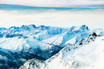 Panoramic view of snow-covered Alps mountains at sunrise. Val Thorens, 3 Valleys, France. Beautiful winter landscape