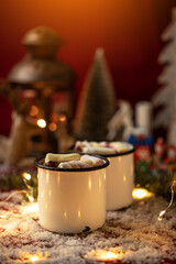 Hot chocolates surrounded with christmas decorations