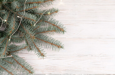 Close-up of green fir winter tree branches on white desk