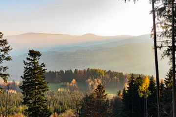 Fototapeta na wymiar Landscape misty panorama. Fantastic dreamy sunrise on rocky mountains with view into misty valley below. Foggy clouds above forrest. View below to fairy landscape. Foggy forest hills.