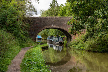 Fototapeta premium Canal boats beyond a bridge