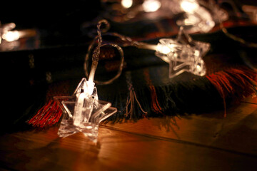stars garland and a warm scarf are on the table