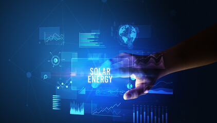 Hand touching SOLAR ENERGY inscription, new business technology concept