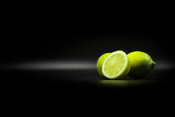Yellow green limes for ingredients in black label background 