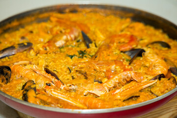 Isolated Spanish seafood paella cooking in white background