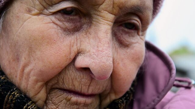 Old grandmother close up. Lonely old woman. Sad old grandmother. Grandma's wrinkled face in close-up. Elderly woman in meditation. The eyes of an aged mother. Loneliness concept in old age