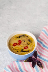 Homemade lentil soup decorated with vegetable oil, sauce and hot red pepper. Minimalistic food concept  with copy space for text