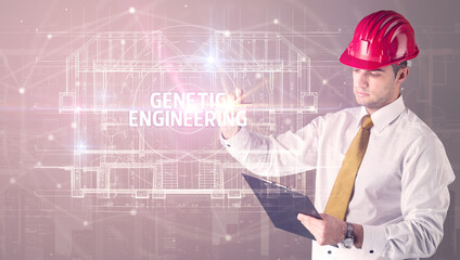 Handsome architect with helmet drawing GENETIC ENGINEERING inscription, new technology concept