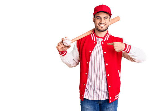 Young Handsome Man Holding Baseball Bat And Ball Pointing Finger To One Self Smiling Happy And Proud