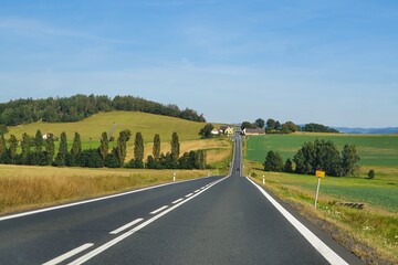Asphalt road cutting through the rural landscape