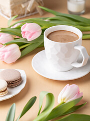 Fototapeta na wymiar Cup of cocoa, macarons and tulips