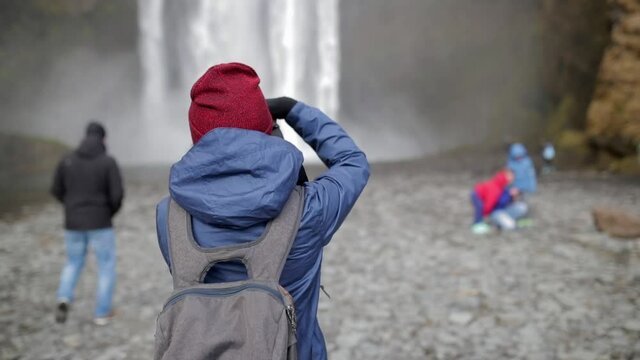 Taking pictures of misty Skógafoss Waterfall in Iceland 