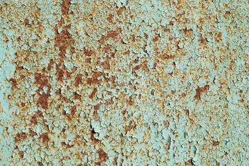 Painted in green old cracked metal rusted background. Metal rust texture. Erosion metal. Scratched and dirty texture on outdoor rusted metal wall.
