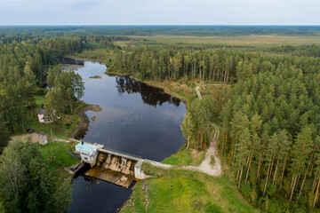 Aerial view of river among the forest. Summer nature landscape. Sunset.