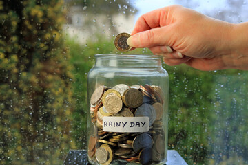 saving money in a jar for a rainy day.