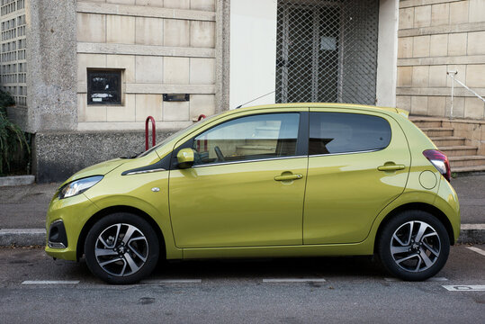 Mulhouse - France - 15 November 2020 - Profile view of  yellow Peugeot 108 parked in the street