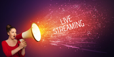 Young woman yelling to loudspeaker with LIVE STREAMING inscription, social networking concept