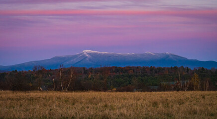 Obraz premium evening dusk lights up snow dusted Mount Mansfield in Vermont 