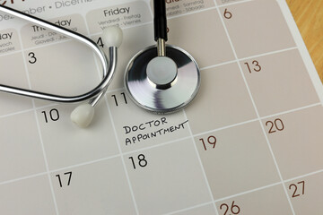 stethoscope on calendar indicating an appointment.