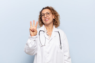 hispanic middle age woman smiling and looking friendly, showing number three or third with hand...