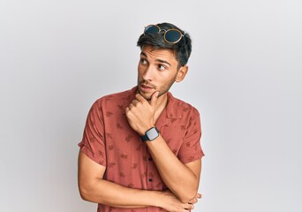 Young handsome man wearing casual summer clothes thinking worried about a question, concerned and nervous with hand on chin