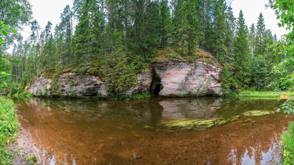 Fototapeta na wymiar Outcrops of Devonian sandstone on the banks of Ahja river, Estonia. 