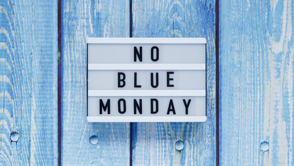 Blue monday day banner concept. White board with text no blue monday on blue wooden background, top...