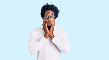 Handsome african american man with afro hair wearing casual clothes and glasses tired hands covering face, depression and sadness, upset and irritated for problem