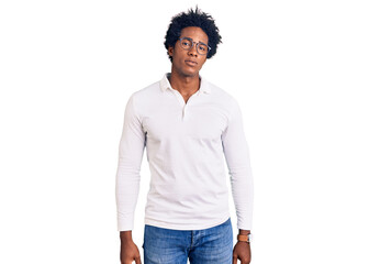 Handsome african american man with afro hair wearing casual clothes and glasses looking sleepy and...